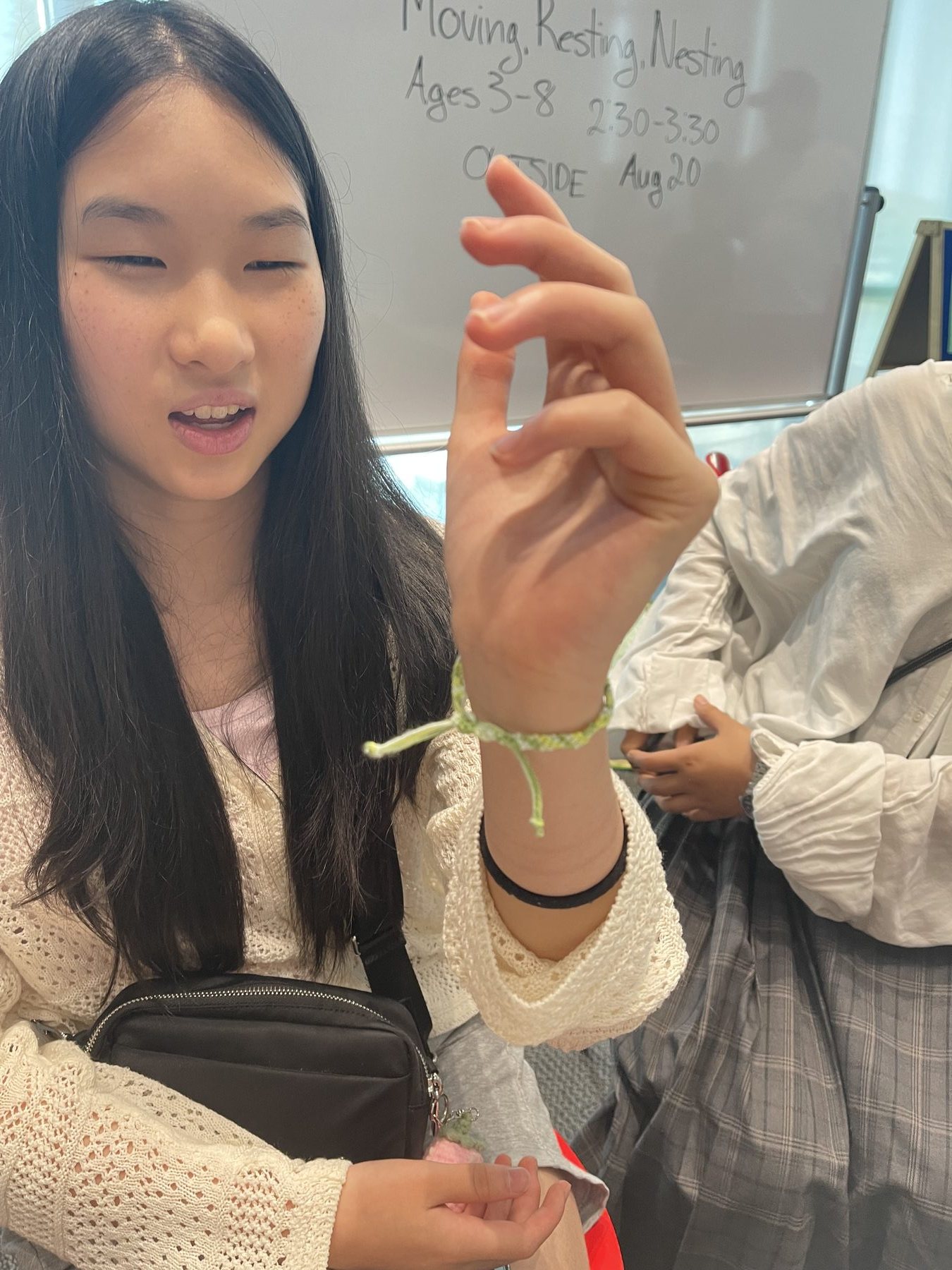 Young person showing a handmade bracelet